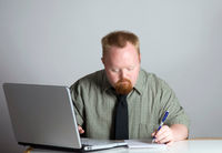 man-writing-laptop on volunteer screening blog
